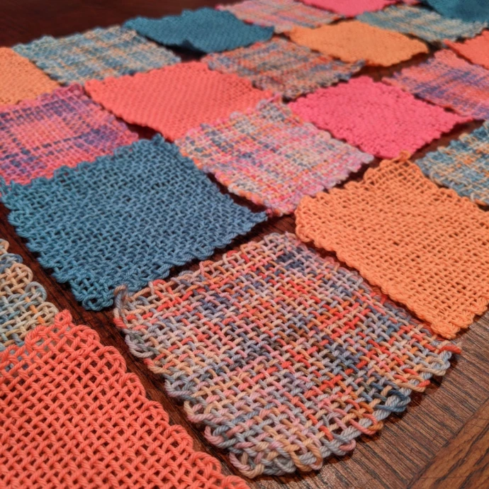 Handwoven fabric swatches, made with hand-dyed yarn in the High Fantasy color palette featuring pink, coral, blue, and multicolor tones for weaving and fiber arts inspiration.