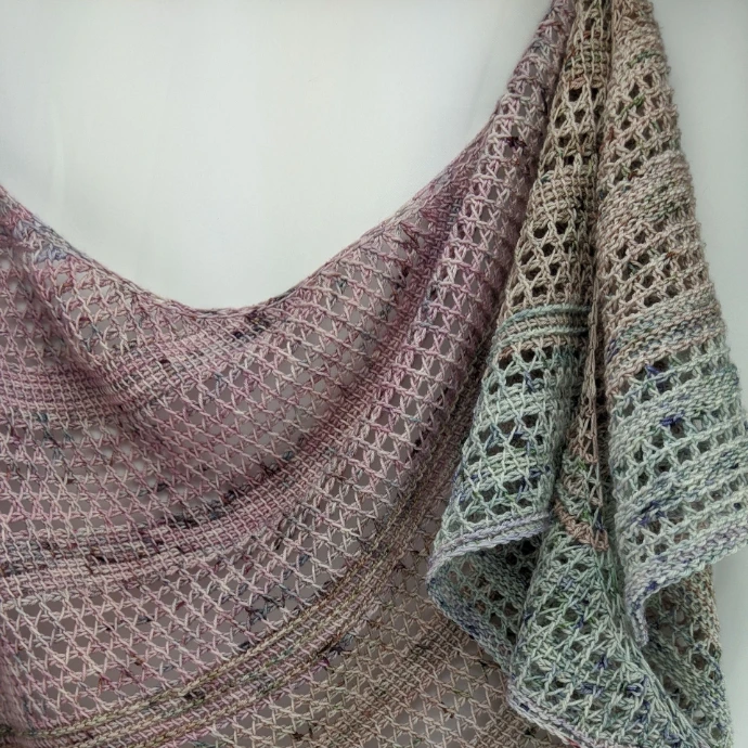 Rattan Tunisian Crochet Shawl featuring an openwork stitch pattern, made in muted colorways from the Dystopian palette.